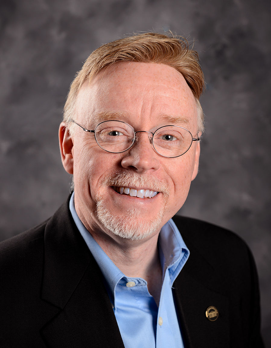 Photos of Keith Fowlkes, Director of Information Technology Services. Date of photos unknown.